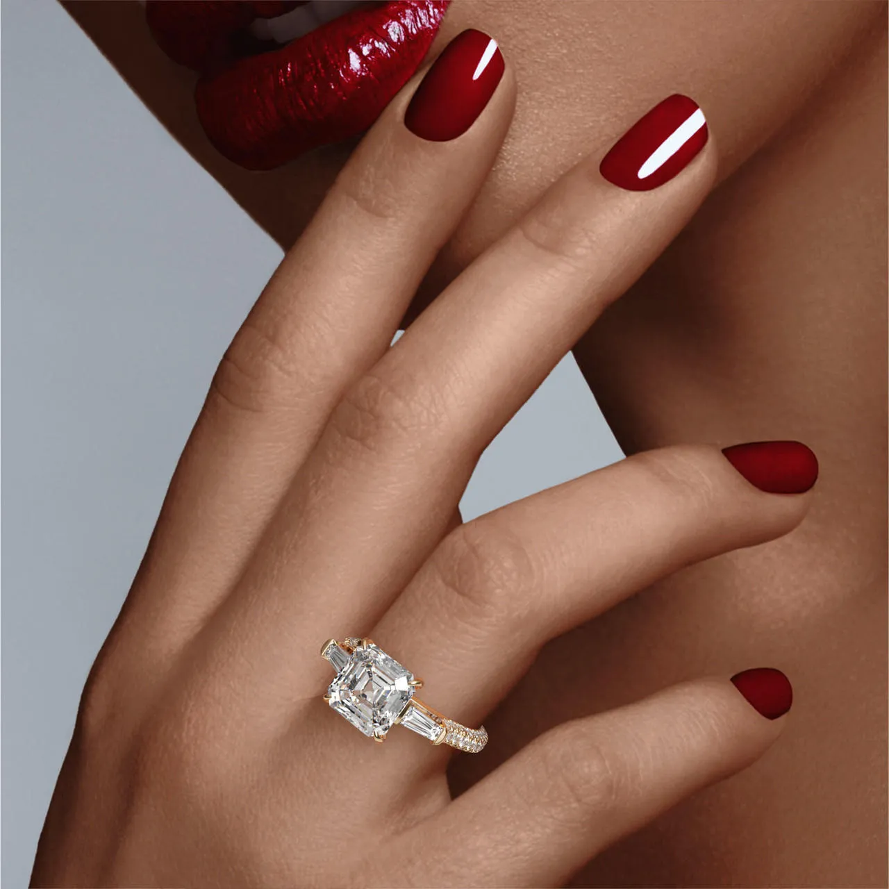 ASSCHER CUT DIAMOND ENGAGEMENT RING WITH A BAGUETTE FLANK THREE PHASES TRIPLE PAVE SETTING IN 18K YELLOW GOLD