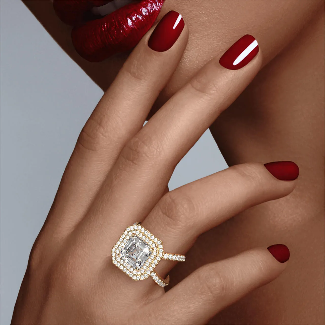 ASSCHER CUT DIAMOND ENGAGEMENT RING WITH A DOUBLE HALO AXIS PAVE SETTING IN 18K YELLOW GOLD