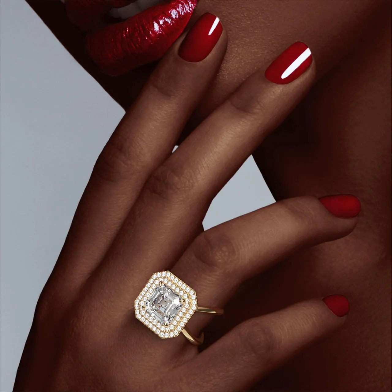 ASSCHER CUT DIAMOND ENGAGEMENT RING WITH A DOUBLE HALO AXIS SETTING IN 18K YELLOW GOLD