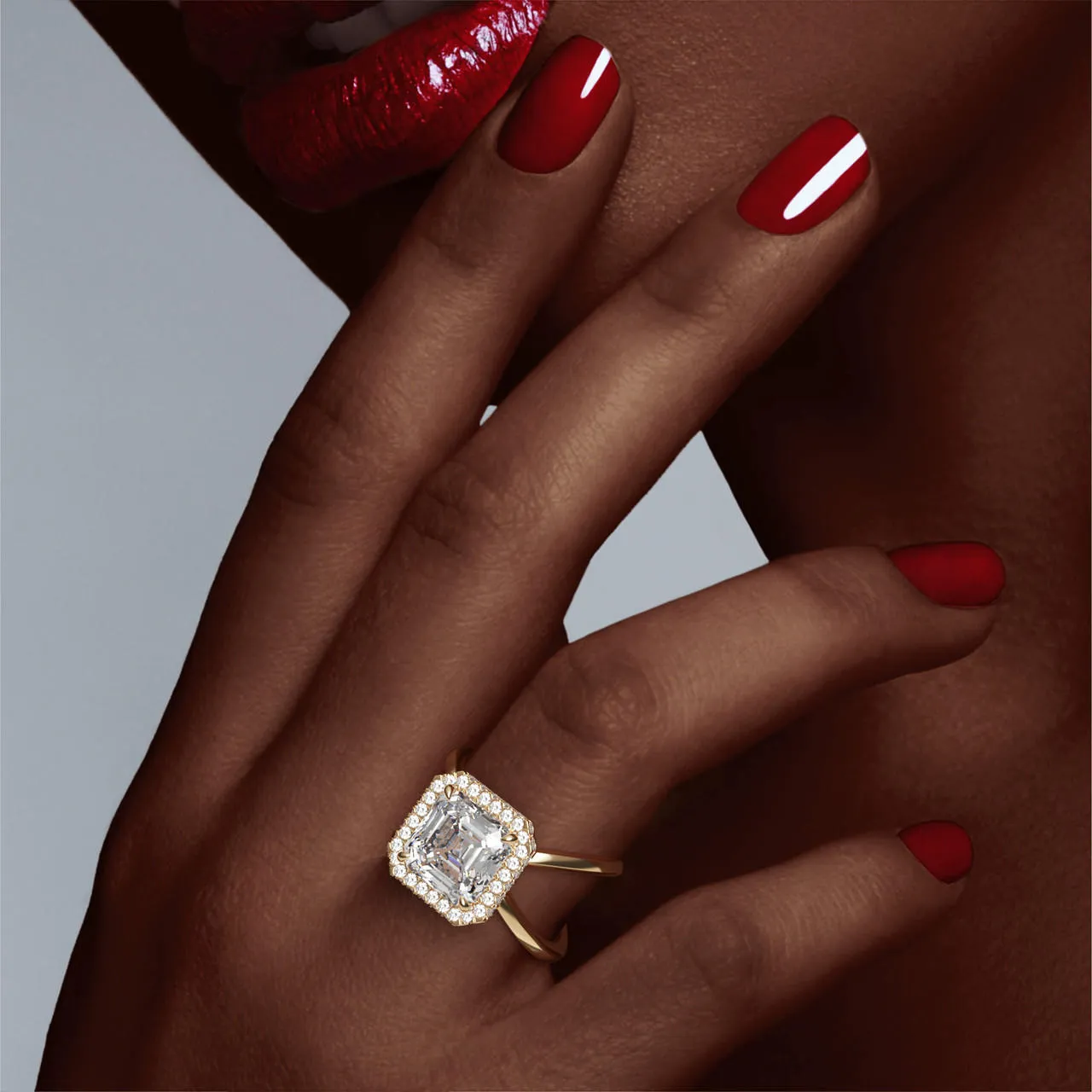 ASSCHER CUT DIAMOND ENGAGEMENT RING WITH A WRAPPED HALO AXIS SETTING IN 18K YELLOW GOLD