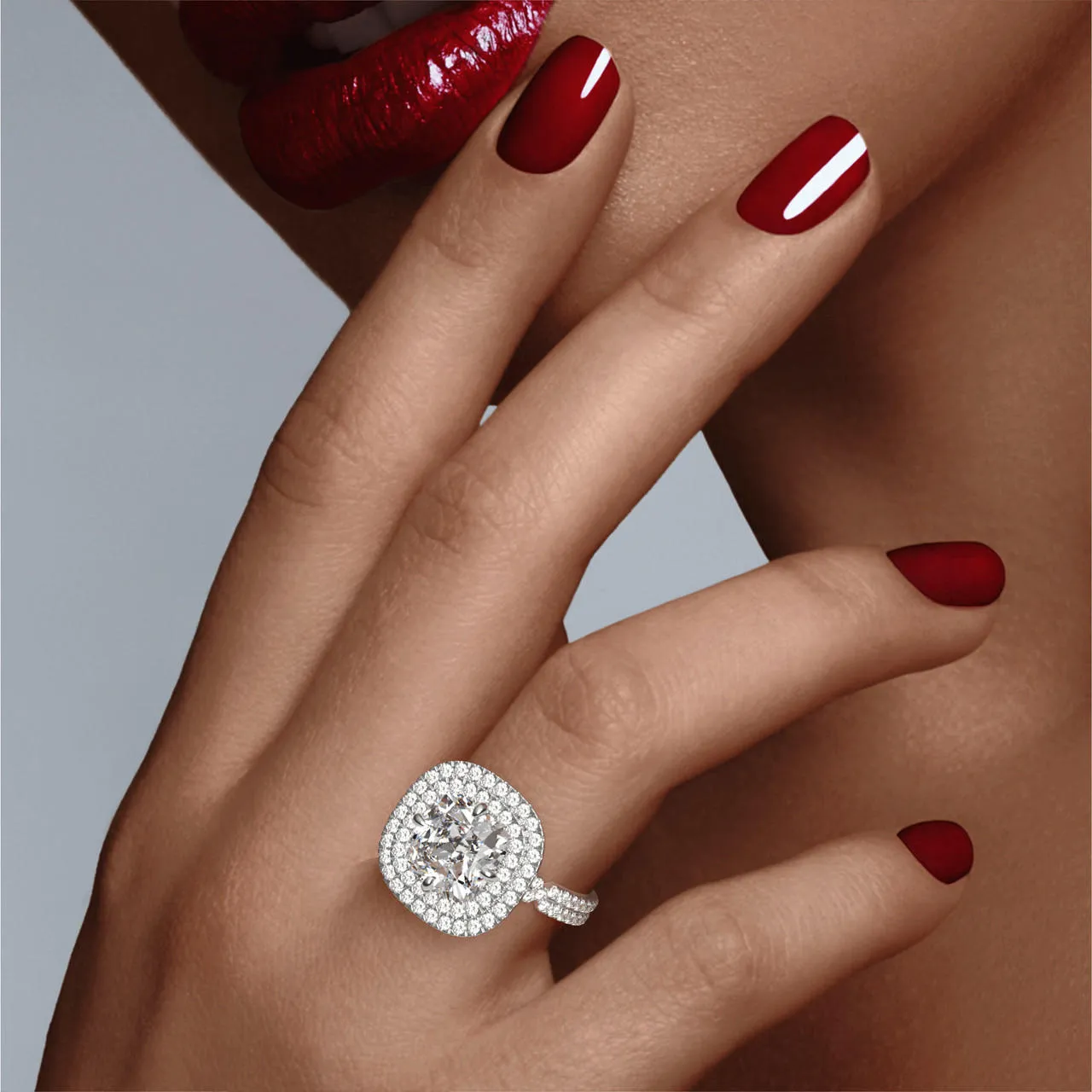CUSHION CUT DIAMOND ENGAGEMENT RING WITH A DOUBLE HALO CHANCE PAVE SETTING IN PLATINUM