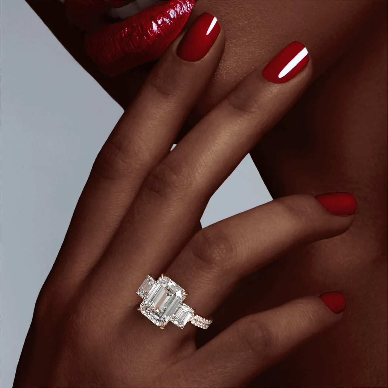 EMERALD CUT DIAMOND ENGAGEMENT RING WITH A THREE STONE CHANCE PAVE SETTING IN 18K ROSE GOLD
