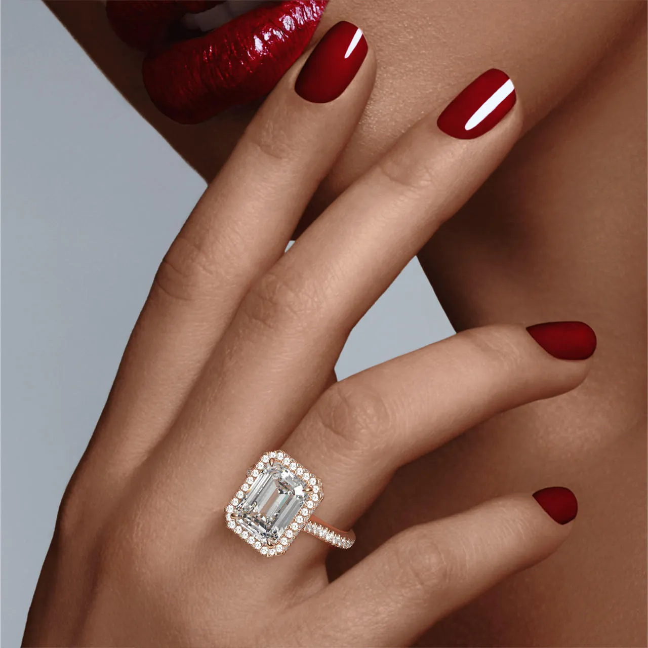 EMERALD CUT DIAMOND ENGAGEMENT RING WITH A WRAPPED HALO THREE PHASES PAVE SETTING IN 18K ROSE GOLD