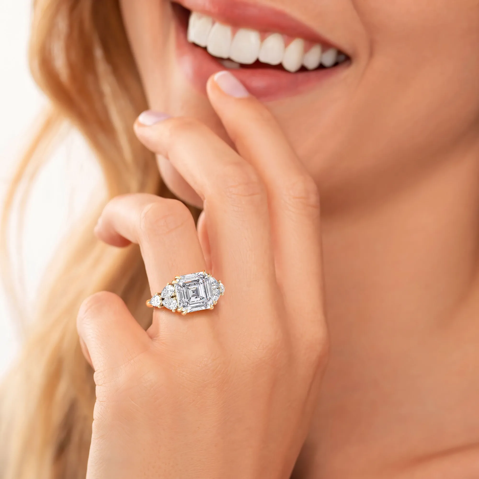 STARLET ASSCHER CUT DIAMOND RING WITH PEAR-SHAPED SIDE STONES