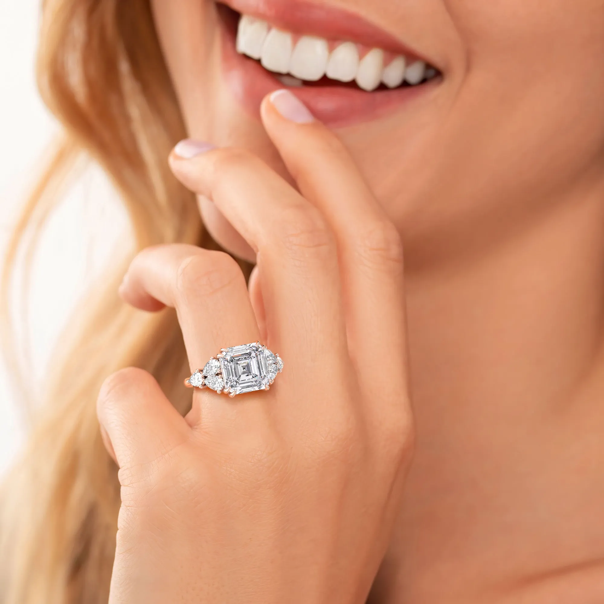 STARLET ASSCHER CUT DIAMOND RING WITH PEAR-SHAPED SIDE STONES
