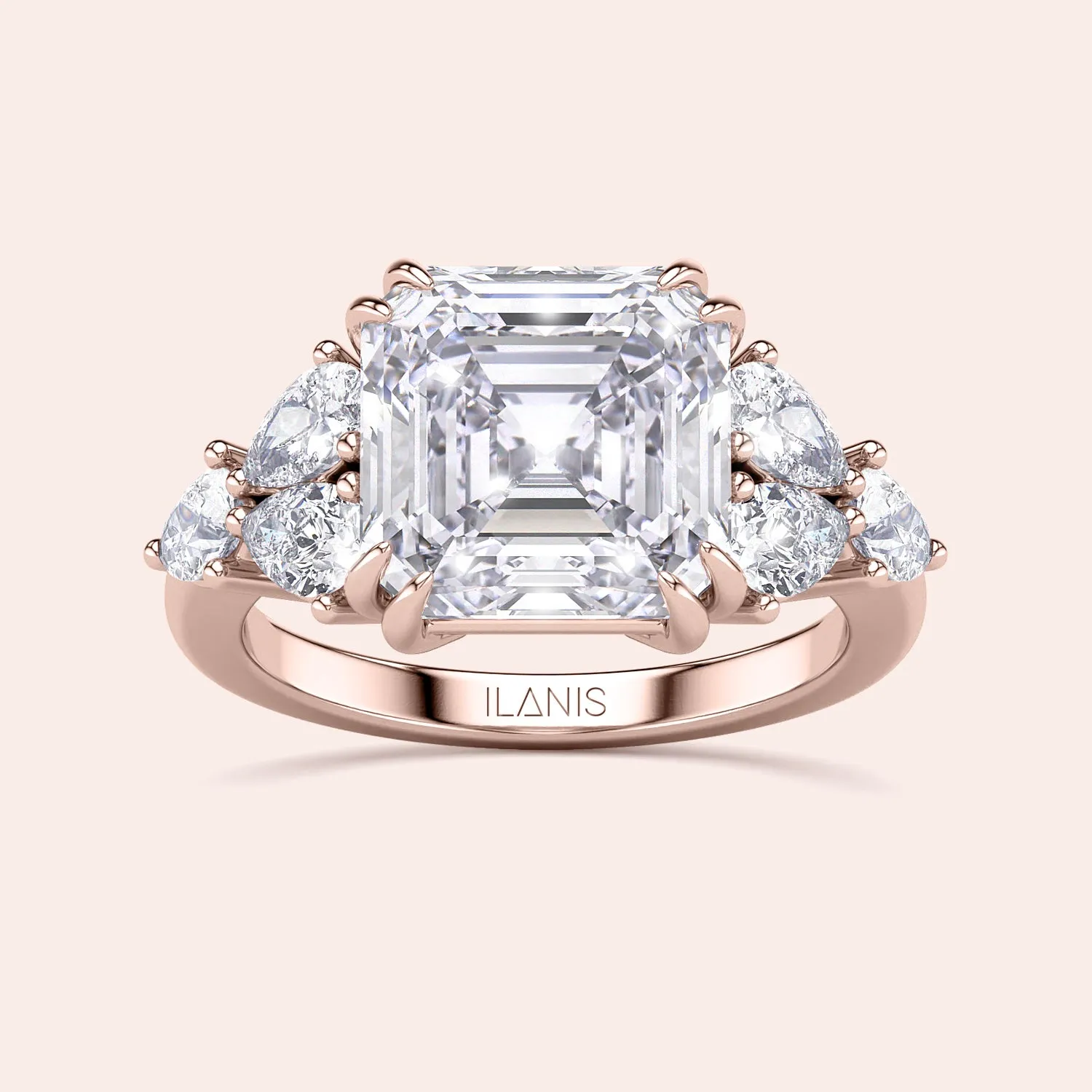 STARLET ASSCHER CUT DIAMOND RING WITH PEAR-SHAPED SIDE STONES