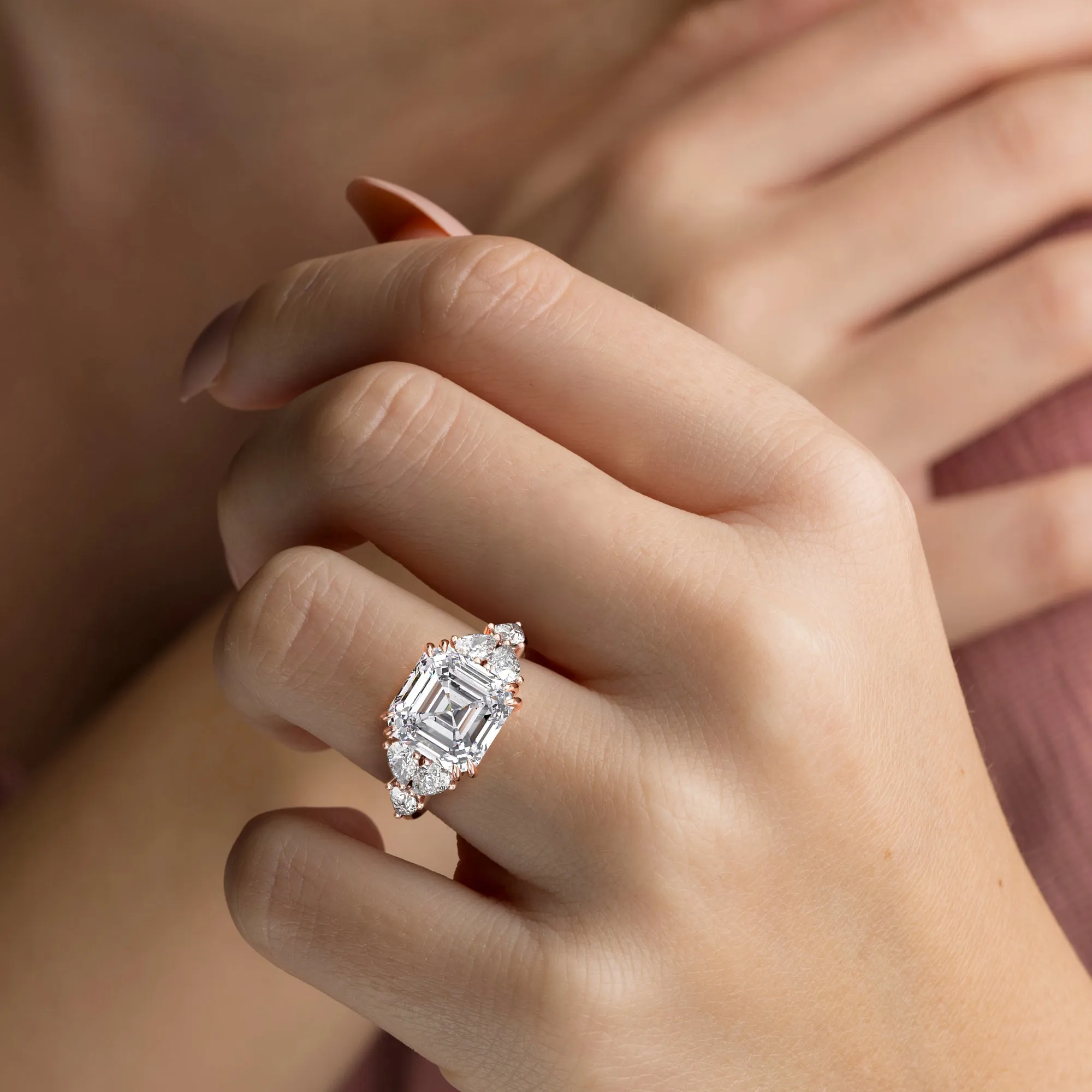 STARLET ASSCHER CUT DIAMOND RING WITH PEAR-SHAPED SIDE STONES