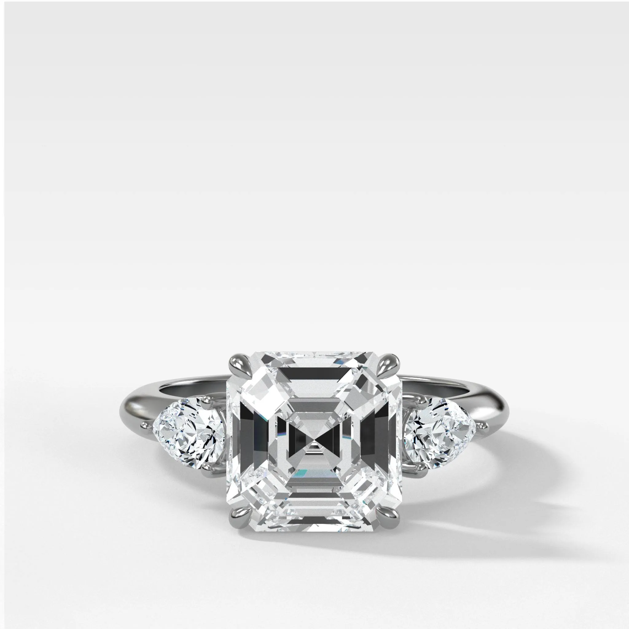 Three Stone Engagement Ring With Pear Side Stones and Asscher Cut Diamond